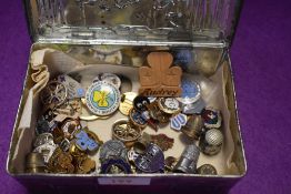 A vintage Riley's toffee tin containing a selection of badges and pins including several Girl