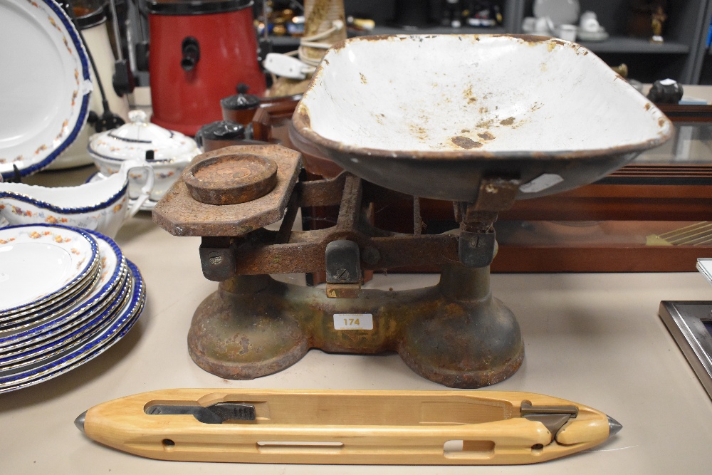 A set of vintage scales and a wooden shuttle.