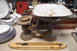 A set of vintage scales and a wooden shuttle.