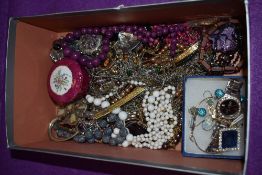 A selection of pendants and strings of beads of various designs, tension bangle and fashion watch