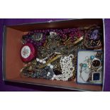 A selection of pendants and strings of beads of various designs, tension bangle and fashion watch