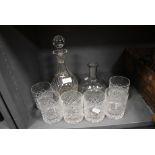 Six glass whiskey tumblers and two cut glass decanters