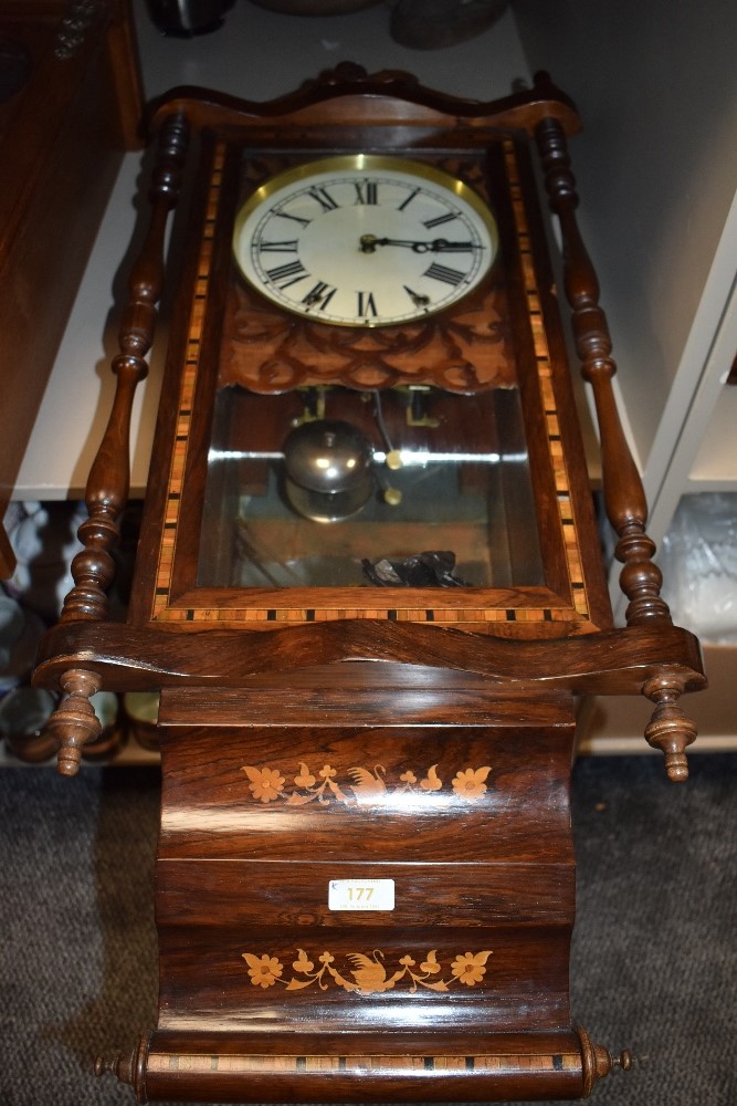 An American style wall clock having ornate casing with inlayed banding.