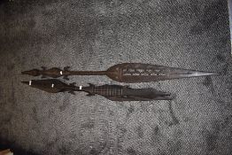 A pair of African tribal hand carved exotic wood spears decorated with crocodile figures and