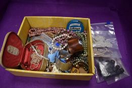 A selection of costume jewellery including loose beads, bangles, brooches etc