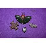 A small selection of jewellery including a British Columbian jade brooch in the form of a butterfly,