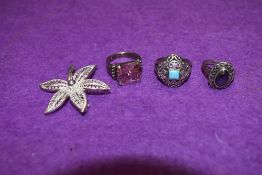 Three silver dress rings and a silver filligree leaf brooch