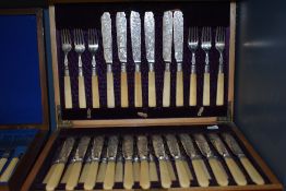 A fine cased canteen of cutlery having etched floral work with bone handles