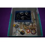 A selection of costume jewellery including yellow metal brooches and a matching set of ear rings and