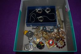 A selection of costume jewellery including yellow metal brooches and a matching set of ear rings and