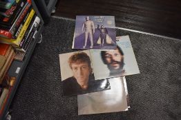 A selection of Beatles related album records including John Lennon and Ringo Starr
