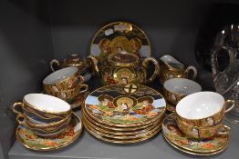 A Japanese part tea set having extensive decoration of samurai