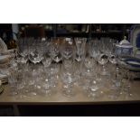 A mixture of wine glasses, vintage etched champagne glasses and unusual sherry glasses having