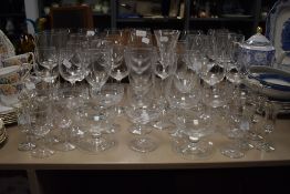 A mixture of wine glasses, vintage etched champagne glasses and unusual sherry glasses having