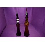 Two hand blown amber and glass decanters having twist decorations