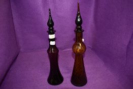 Two hand blown amber and glass decanters having twist decorations