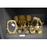 A selection of brass wares including a pair of goblets and a deer figure