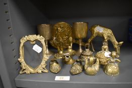 A selection of brass wares including a pair of goblets and a deer figure