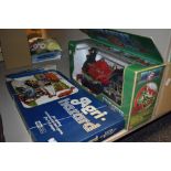 A vintage Agri hazard board game and A boxed steam engine toy.