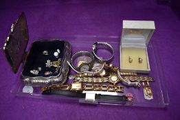 Seven modern costume wrist watches and a silver plated casket containing a small selection of clip