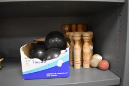 A set of Banda crown green bowls and similar wooden skittle sets