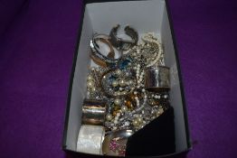 A box of costume jewellery including wrist watches, bangles, necklaces, white metal napkin rings