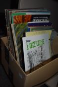 A box of magazines or art and painting and drawing interest.