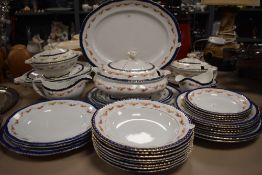 A part tea and dinner service having cobalt and gilt glaze with tureens and soup bowls etc