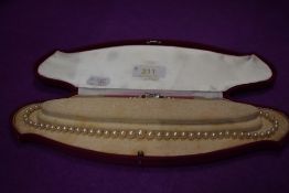 A graduated cultured pearl necklace having silver box clasp, approx 18'