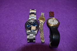 Two gents wrist watches, a ladies wrist watch and a royal souvenir charm
