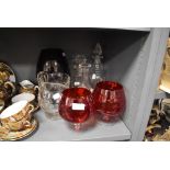 A selection of glass wares including two medium sized cranberry brandy glasses and a larger example