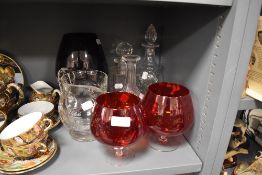 A selection of glass wares including two medium sized cranberry brandy glasses and a larger example