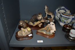 Four figure studies of animals including Border Fine Arts otter figure