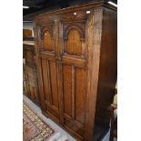 An early 20th Century oak priory style wardrobe