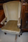 A traditonal oak frame and green dralon wing back armchair, good heavy quality