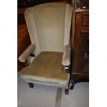 A traditonal oak frame and green dralon wing back armchair, good heavy quality