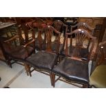 A set of six (five plus one) slat back dining chairs having studded leather seats (in need of
