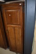 An early 20th Century oak hall robe having panel doors