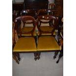 A set of four Victorian mahogany balloon back dining chairs on turned legs, later gold dralon