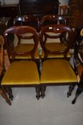 A set of four Victorian mahogany balloon back dining chairs on turned legs, later gold dralon