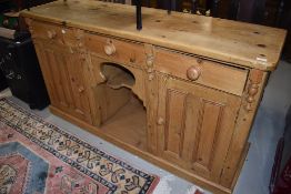 A traditional stripped pine dresser base, width approx. 153cm