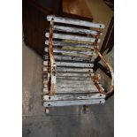 A vintage garden chair having slatted wooden seat and scrolled metal arms and feet.