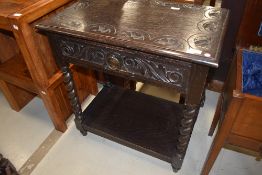 A late Victorian dark stained side table with twist frame and carved lunette top