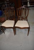 A pair of reproduction Regency feather back dining chairs