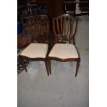 A pair of reproduction Regency feather back dining chairs