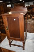 A late 19th or early 20th Century mahogany pot cupboard having open slat back