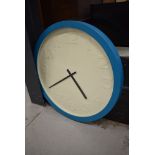 An oversized industrial style wall clock , teal blue frame, named for Karlsson, diameter approx.