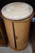 A Victorian pot cupboard of cylindrical form with marble top, very bleached