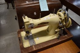 A vintage 1930s Vickers BSM enamelled hand crank sewing machine, in wooden case