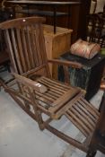 A teak rocking garden recliner chair